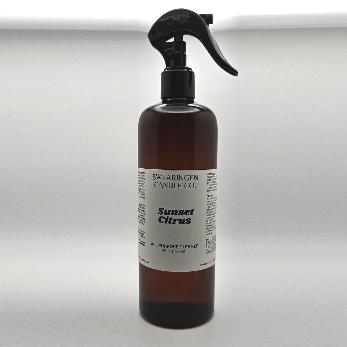 Sunset Citrus all purpose cleaner in an amber plastic spray bottle, shown from the front - Swearingen Candle Co.